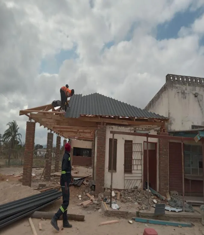 Workers fixing roof sheeting on a steel gazebo